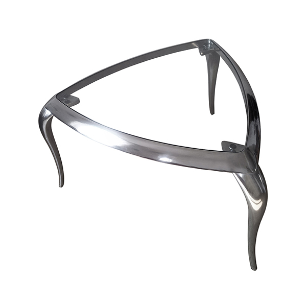 T-Table is a modern small triangular table made in polished aluminium and crystall top