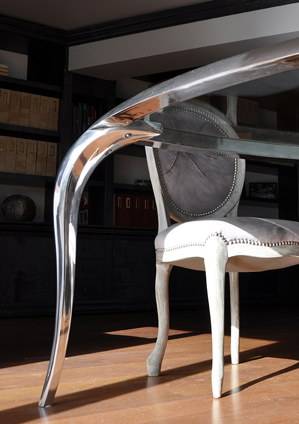 T-Table is a modern small triangular table made in polished aluminium and crystal top