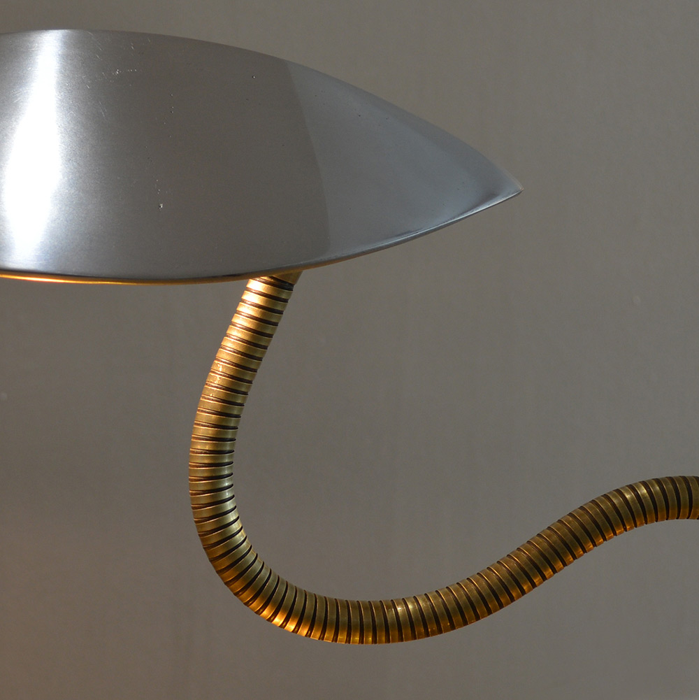 Kalimero is a table lamp made in polished aluminium and brass flexible neck